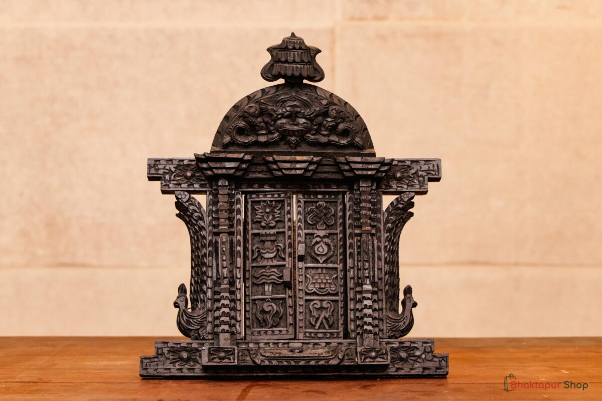 Decorative wooden door with Astamangal symbols and toran